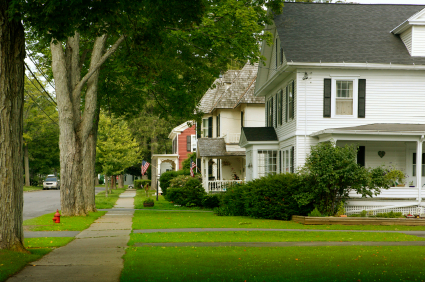 suburban street with green lawns and houses 